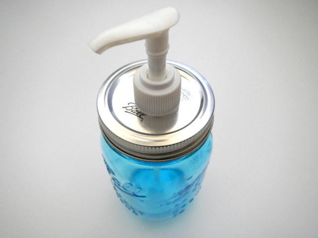 mason jar soap and lotion dispenser in blue glass canning jar